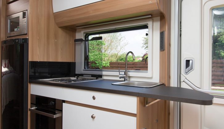 A hinged flap on the right-hand side of the kitchen greatly extends the workspace, but doesn’t obstruct the door too much – the kitchen cupboards look stylish, too