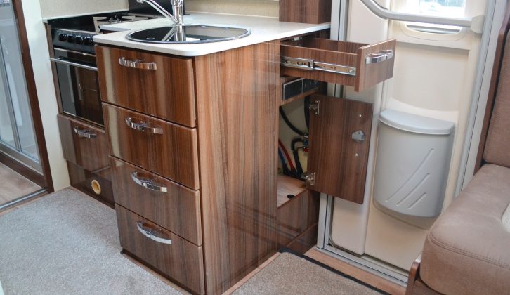 A clever drawer and cupboard right by the door can be used whether you are inside in the kitchen or outside eating al fresco