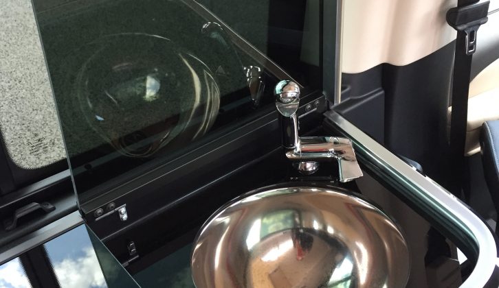The worktop has a smart, curved edge, while the tap can be folded down, into the circular sink