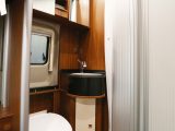 Globecar pioneered the use of walk-through washrooms in van conversions – space is tight, but you get a swivel cassette toilet and a vanity unit, with a mirrored cabinet above!