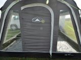 The SunnCamp Impact Motor Air 350 Grande's front door is flanked by windows with curtains