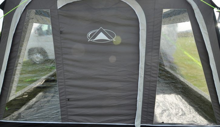 The SunnCamp Impact Motor Air 350 Grande's front door is flanked by windows with curtains