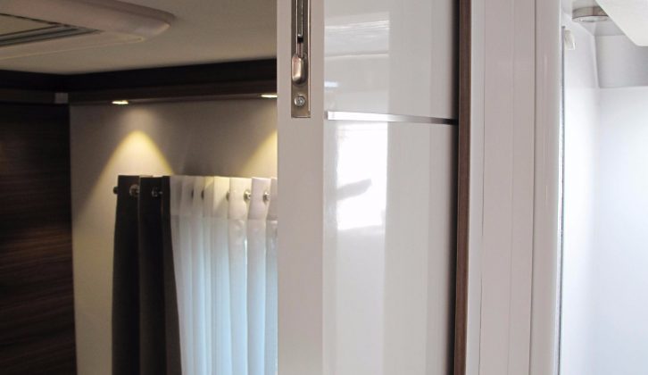 A sleek partition door provides privacy for those in the master suite of Le Voyageur models