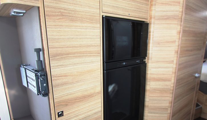 The fridge and wardrobe are opposite the kitchen – the latter is designed to be used by those in the drop-down bed