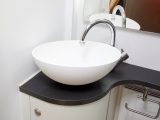 This smart sink sits on a circular vanity unit carrying the same finish as the kitchen, so everything looks sharp and contemporary