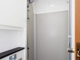 The separate shower compartment is accessed via a bi-fold door and has a pair of lights in the roof, plus a handy clothes-drying line