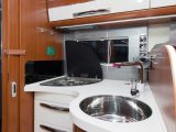 The extractor fan included in this spacious kitchen is a definite plus, as is the splashguard next to the three-burner hob