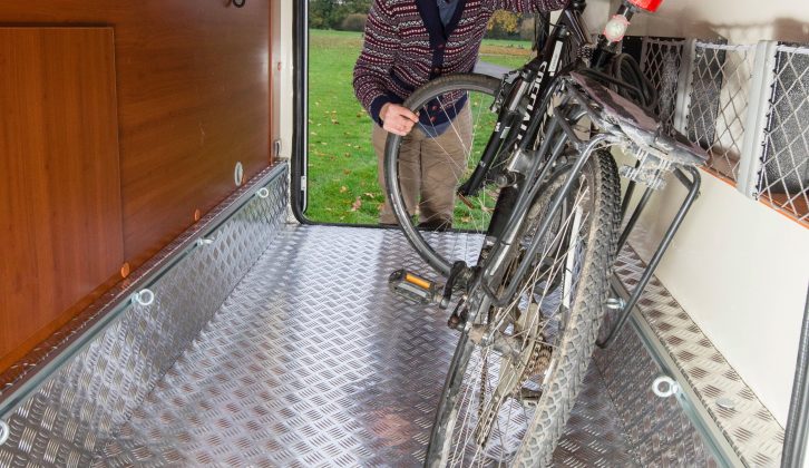 The garage at the back is well lit and easily tall enough to fit cycles in an upright position