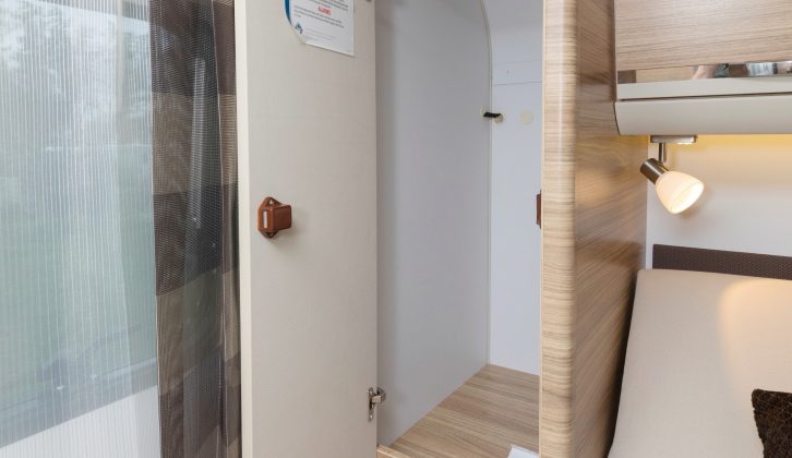 There are half-height wardrobes on either side of the bed that provide plenty of hanging space