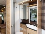 The washroom and its basin are both compact, but good lighting, storage and clever design make this an easy-to-use room