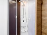 The shower cubicle’s door slides round on a track to clip together – the hanging rail is perfect for drying towels and clothes