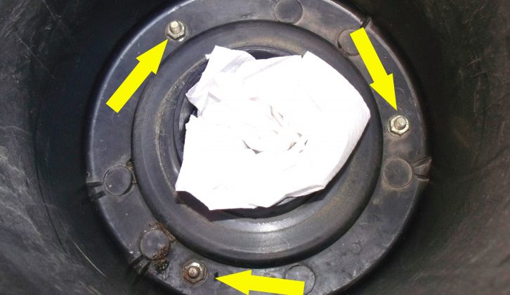 The arrows above point to the three retaining nuts that need to be removed – the rag is to catch any dropped nuts!