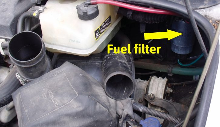 The main air filter body is tucked under the radiator, with the fuel filter in the background