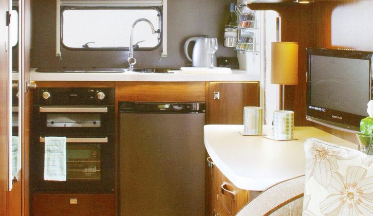 The Elddis Aspire 215 has an end-kitchen floorplan – dark ‘woodwork’ was later changed for a lighter shade, still with white gloss doors