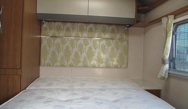 The attractive headboard lends the area a domestic feel and there are lockers above