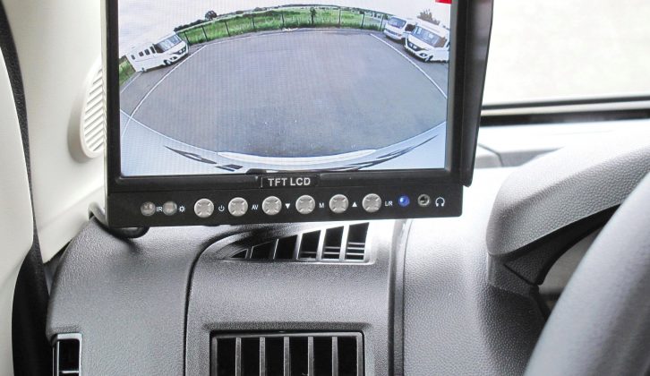 A retrofitted monitor sits to the left of the steering wheel and provides a 170-degree view of the area behind the Pilote