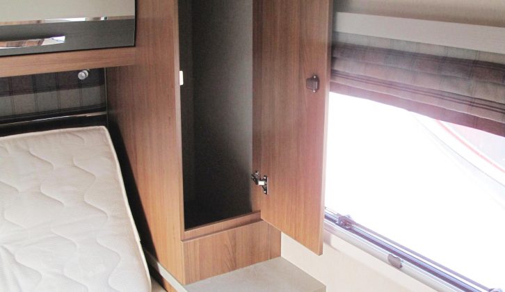 The bedroom has ample storage for clothes, with two substantial wardrobes and more cupboard space below the bedside tables