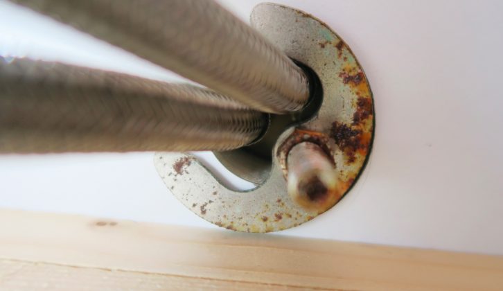 The final step to release the tap is to unscrew the bolt underneath the kitchen worktop, which secures the tap in place