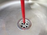 Before you can lift out the sink, you will also have to release the screw in the middle of the plughole