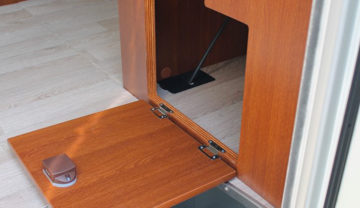This storage space under the sofa by the door could be used for shoes and boots