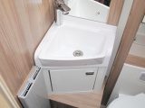 The washroom is brightly lit and well kitted out, with a small handbasin, two cupboards, an Alde radiator and shelves above the Thetford C260 cassette toilet with electric flush