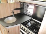 Raise the lid of the four-burner dual-fuel hob and you lose some natural light, but note the useful shelf near the pair of mains sockets