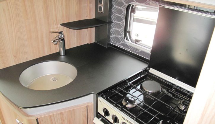 Raise the lid of the four-burner dual-fuel hob and you lose some natural light, but note the useful shelf near the pair of mains sockets