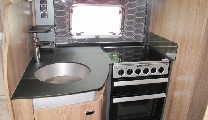 There is a snazzy splashback in this well-lit kitchen, plus a smart Fenix scratch-resistant worktop