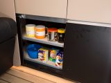 There is a cutlery drawer under the sink and other storage space in the kitchen, including this sliding-doored cupboard