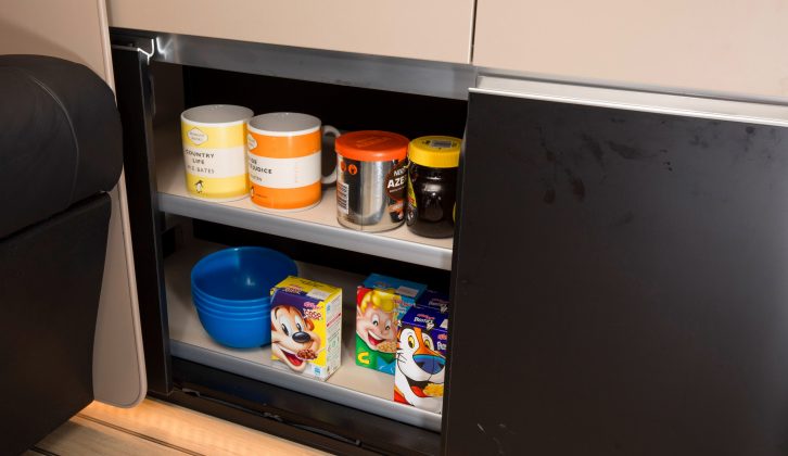 There is a cutlery drawer under the sink and other storage space in the kitchen, including this sliding-doored cupboard