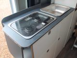 Cooks get a two-burner Dometic gas hob with a glass cover, a square sink and a 90-litre fridge/freezer, but there's no oven