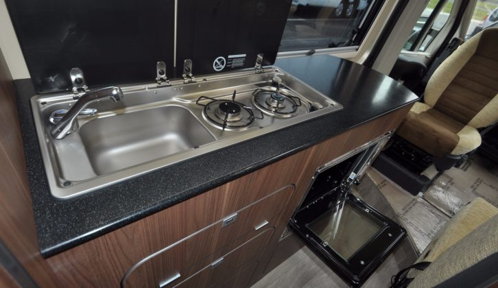 Lift the covers to reveal the combined sink and twin-burner unit in the Autohaus Kingston's kitchen – you get a combined oven/grill, too