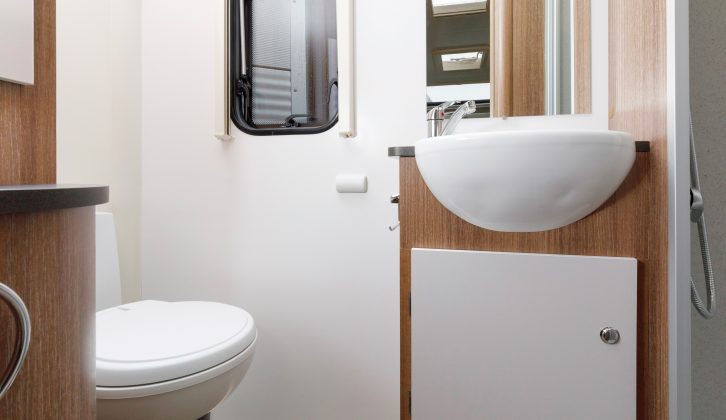 White-and-wood-coloured fittings in the washroom appear smart, and there's room to dress in here, too