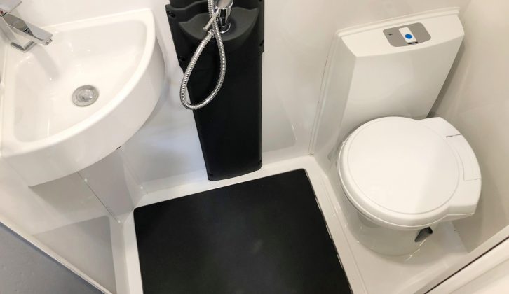 The shower cubicle isn't separate, but the black-plastic floor helps channel water into the three plugholes