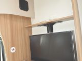 Stowaway flatscreen TV behind lounge’s single seat is just one of many clever features.