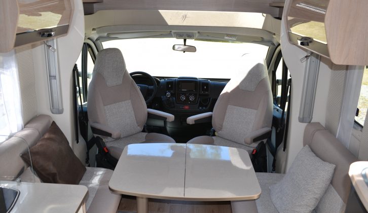The 'van's interior is bright and airy, and the face-to-face sofas have travel seats underneath.