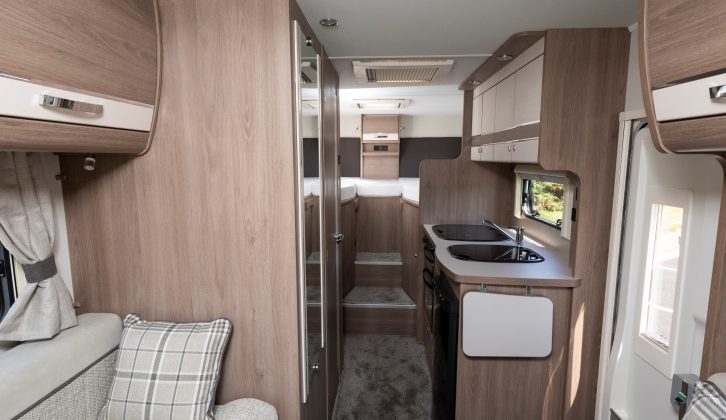 The Avantgarde 194 is a four-berth with high fixed single beds over a garage at the back and a front dinette with two parallel sofas that make a second double