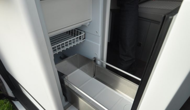 The compressor fridge with freezer compartment sites just inside the sliding door, so you can access it from inside and outside the 'van