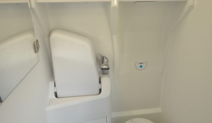 The washroom includes a Thetford swivel toilet, fold-down sink and a shower