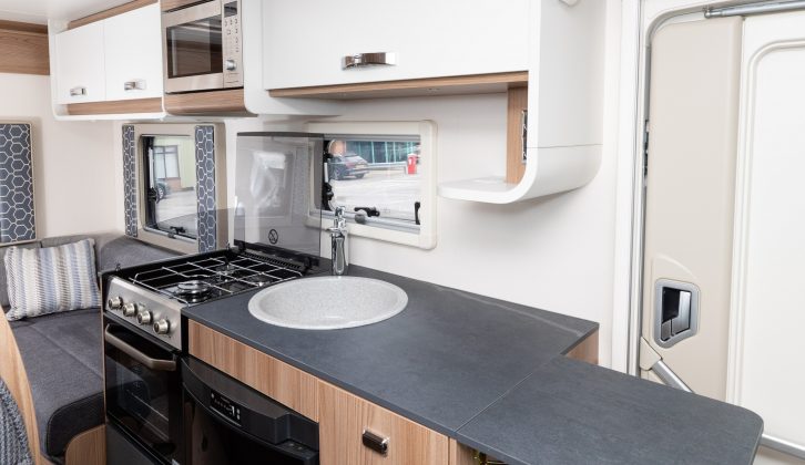 The galley kitchen is well-equipped with a workspace extension that gives plenty of room for food preparation