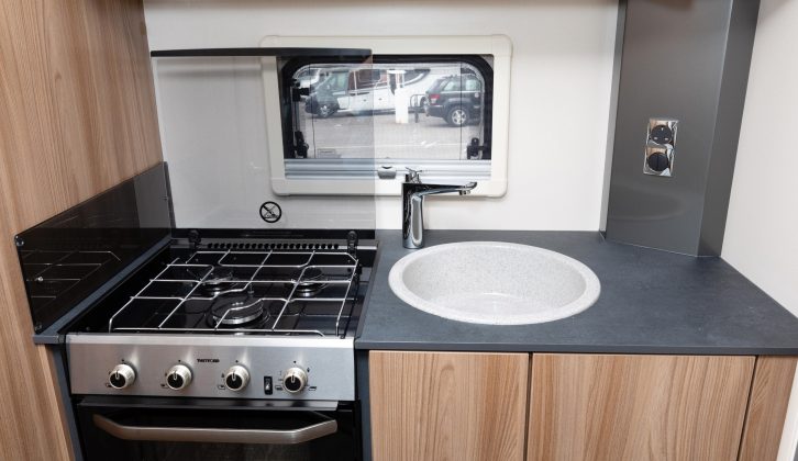 The kitchen features a deep sink and attractive grey worktop