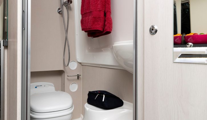 The corner washroom is narrow, with much of the floor space taken up with the wheel arch