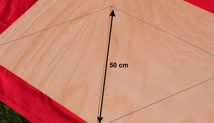 Marked-up plywood. Each side of the triangles should be 50cm long. Now cut out the triangles using a tenon saw