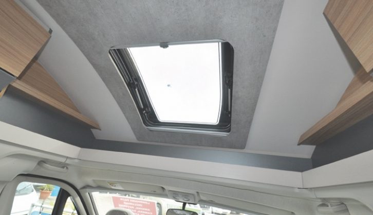 Contrasting ceiling panels include ambient lighting