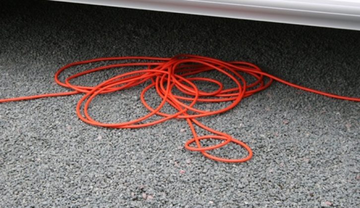Unwind all of the hook-up cable to avoid any risk of it overheating and catching fire, and place underneath the motorhome