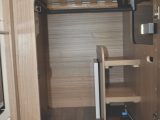 The second wardrobe, which has some useful shelving, is located underneath the bed