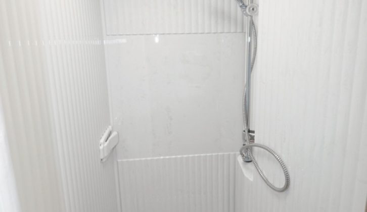 Simply swing the sink away and you have a full-size shower area