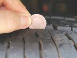Insert a 20p coin into the main tread and, if the outer band is obscured, the tyre's tread depth is within the legal limit