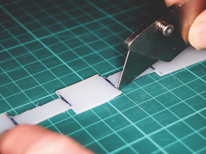 Using a craft knife, carefully cut out the apertures as marked