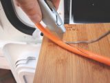 Cut carefully along the length of the orange cable